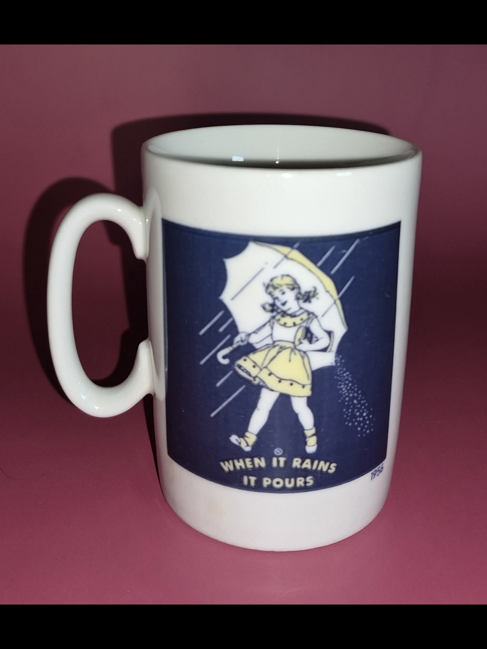 White Ceramic Mug with Yellow Graphic "When It Rains It Pours"